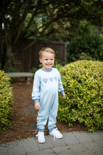 Boy wearing Grace and James Kids heart applique romper for valentines