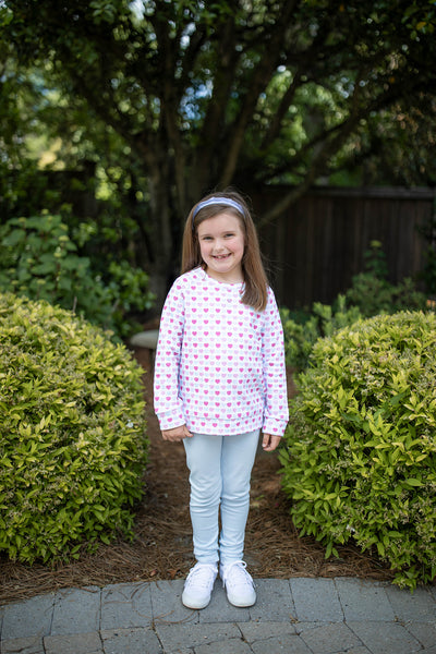 Girl wearing Grace and James Kids heart crewneck and leggings set for valentines