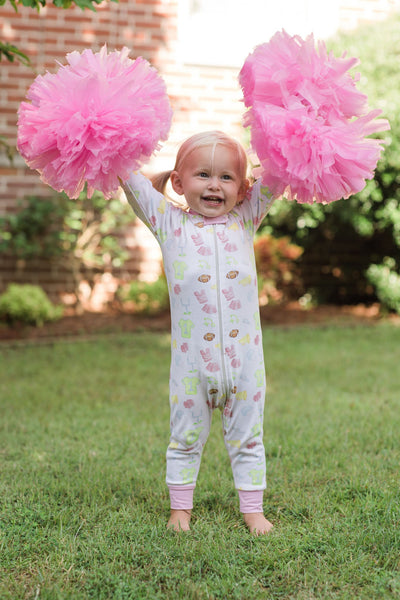 Little Girl Smiling in Custom Print Cheerleader Loungewear Onesie with Pink Details