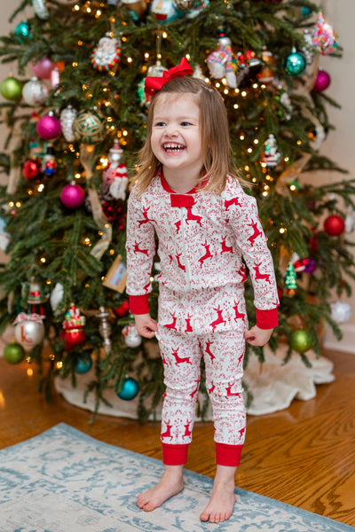Little Girl Wearing the Festive Rudolph Onesie with Matching Red Bow