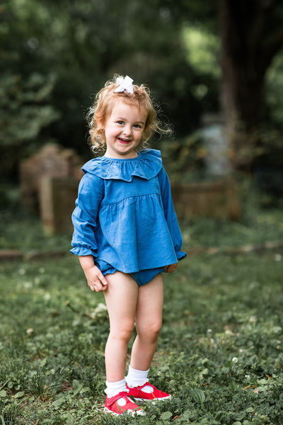 Girl Wearing Blue Molly Diaper Set with Red Shoes