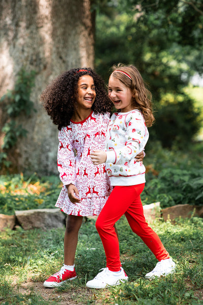 Girls Coordinating in the Festive Letters to Santa Crewneck Sweater and Leggings Set and the Rudolph Dress
